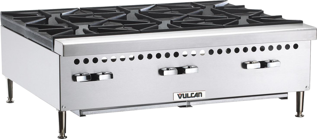 A commercial stainless steel gas countertop range featuring four black cast iron burners, two control knobs on each side, vent holes above the knobs, and sturdy metal legs. The “Vulcan” brand name is displayed on the front panel.