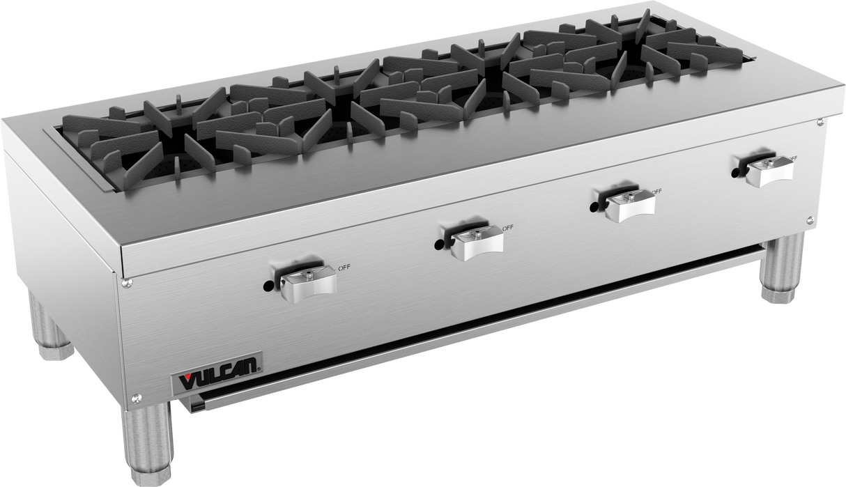 A commercial stainless steel gas countertop hotplate features four large black cast iron burners, each controlled by a front knob. The range stands on four short legs and has a Vulcan brand logo on the lower left corner.