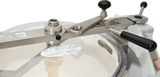 Close-up of a Hobart HCM450-62 Cutter Mixer pressure cooker lid with a metal locking lever, two handles, warning labels, and safety instructions. The partially transparent lid shows internal components and features caution stickers for safe operation.