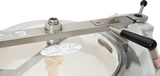 Close-up of a Hobart Cutter Mixer autoclave lid with a black handle, warning labels, instruction sticker, and a round transparent section at the center. The plain white background highlights its safety features and stainless steel bowl design.