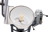 A close-up of a Hobart Cutter Mixer food processor with a large white bowl, central beige plastic handle, and sharp metal blades. The machine features a control panel with black levers and red and green buttons labeled START and STOP.