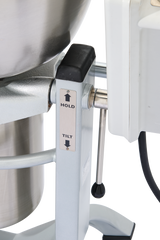 Close-up of a Hobart HCM450-62 base, showing a lever with HOLD and TILT positions. An arrow points upward by each label. A thick power cord extends from the right side, and part of the silver bowl and Knead-Mix attachment are visible.