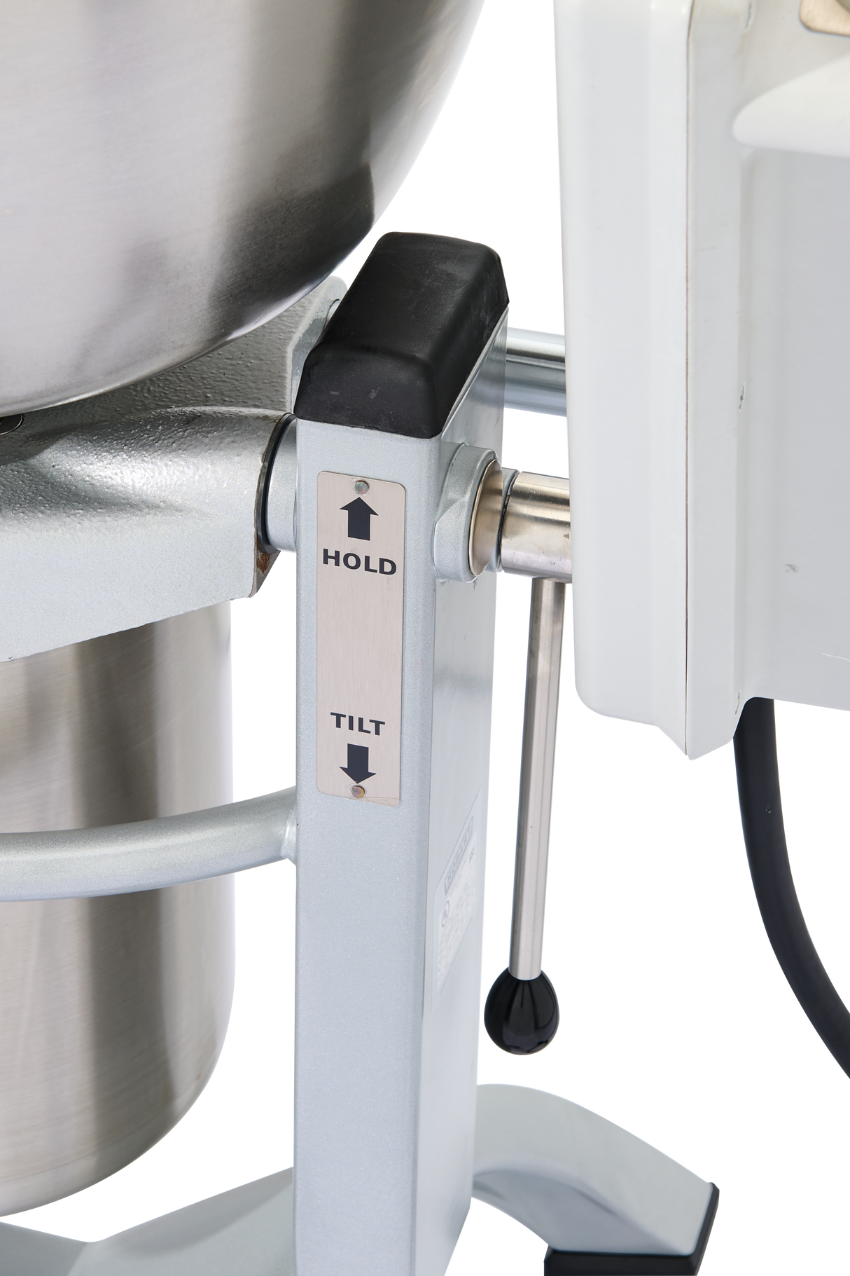 Close-up of a Hobart HCM450-20 industrial mixer stand with two labeled buttons—HOLD and TILT, each with an upward arrow. Part of the mixing bowl and white cutter mixer body is visible, plus a black cable on the right. Background is white.