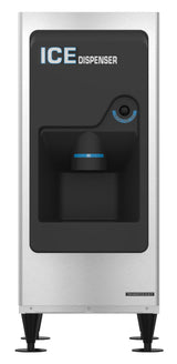 A stainless steel Ice Dispenser with black accents, labeled ICE DISPENSER at the top. This ADA compliant appliance stands on four black legs, has a modern rectangular design, and features a centered dispensing area below a round push button. 130-lb. storage capacity.