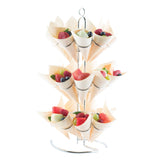 A TableCraft 3-tier cone holder displays paper cones filled with assorted fresh fruits—strawberries, blueberries, grapes, and melon slices—arranged neatly for serving or decorative presentation.