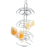 A 3-tier metal TableCraft cone holder with circular holders is designed for cone-shaped items. Four light-colored wooden cones sit on the right side, while a handle on top and a curved base ensure easy transport and stability.