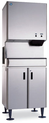 A large cubelet-style commercial ice maker with a stainless steel exterior, two black dispensing buttons, and a storage cabinet below with double doors and four legs. The sleek, industrial design is ideal for restaurant or cafeteria use.