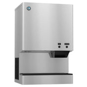 A stainless steel Cubelet-Style ice and water dispenser mounted on a wall, featuring a rectangular shape, two labeled push buttons—one for ice and one for water—and a black dispensing area below with a drip tray.