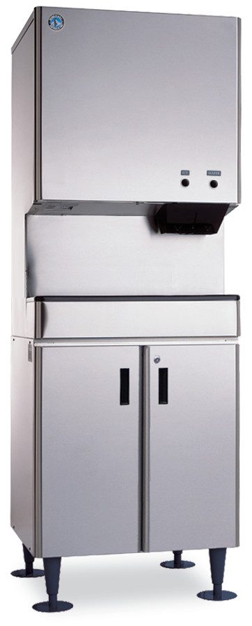 A tall, stainless steel Hoshizaki DCM-500BWH with a boxy top dispenser, control buttons, and a lower cabinet on four black legs. This Opti-Serve Ice Maker features a logo on the top left and black handles on the cabinet doors below.