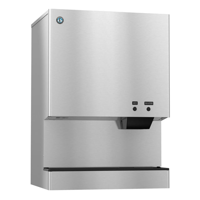 A stainless steel commercial cubelet-style ice and water dispenser with a rectangular shape, touch buttons labeled ICE and WATER, and a smooth, reflective surface. A small blue logo is in the upper left corner above the dispensing area.