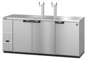 A commercial Stainless Steel Beer Cooler kegerator with three front doors, a digital control panel on the left, and two tall draft beer towers with dual taps on top. The flat countertop surface appears clean and reflective.