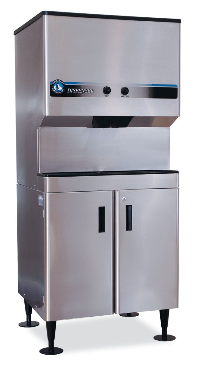 A large, stainless steel commercial ice and water dispenser stands on an equipment stand with four black legs. The stainless steel cabinet features double doors below, a DISPENSER label above, two buttons for ice and water, and an open dispensing area.