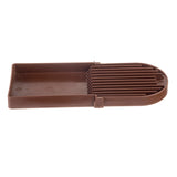 A brown rectangular plastic slicing guide with parallel vertical slots and a flat base, used to hold items steady for even slicing. Features a rounded end, simple utilitarian design, and is dishwasher safe for easy cleaning.