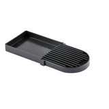 A black rectangular plastic slicer with parallel raised grooves and a half-rounded end. The left section is flat with raised edges, while the right has vertical slots for guiding slicing. This dishwasher safe tool is ideal for foods like eggs or mushrooms.