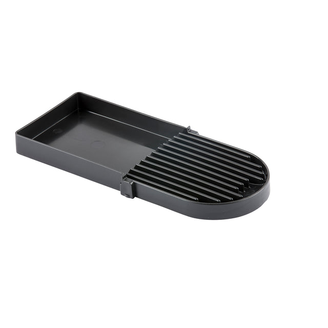 A black rectangular plastic slicer with parallel raised grooves and a half-rounded end. The left section is flat with raised edges, while the right has vertical slots for guiding slicing. This dishwasher safe tool is ideal for foods like eggs or mushrooms.