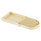 A beige plastic kitchen tool with a flat rectangular base and evenly spaced vertical slots at one end for slicing eggs or vegetables evenly. Dishwasher safe and easy to clean, it features smooth, slightly raised edges for added convenience.