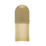 A beige plastic kitchen slicer with a flat base and vertical slots for guiding a knife. The top features curved edges and evenly spaced ridges for slicing, while the bottom forms a shallow rectangular drip tray. Dishwasher safe and made in USA.