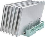 Six shiny metal baking trays are arranged vertically in a Hobart rack with metal dividers. The sheet pan rack keeps the 6 sheet pan trays separated and upright, showing their flat, rectangular shapes and reflective surfaces.