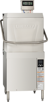 A Hobart commercial dishwasher with a stainless steel exterior features digital controls, a handle across the upper front, and an electronic display screen. This door type dishwasher includes detailed safety and operation labels on the lower front panel.