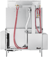 The image shows the back view of a large conveyor dishwasher. Red hoses and silver pipes cross the metallic back panel, with electrical and water connection points visible. The machine stands on short legs, featuring advanced automatic soil removal systems.