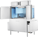 A large, industrial MEIKO conveyor dishwasher stands on metal legs with one door open, revealing light blue panels and spray arms. The control panel sits on top, featuring automatic soil removal for efficient cleaning and performance.