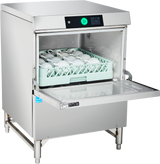An ADA compliant undercounter dishwasher with its front door open reveals a green rack filled with white cups. The commercial stainless steel unit features a digital control panel with a green button and stands on four metal legs against a white background.