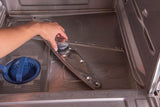 A person’s hand removes or installs the lower spray arm inside an empty stainless steel Hobart LXn Dishwasher. The blue filter basket and fine mesh filter are visible on the left side of the undercounter dishwasher’s clean, metallic base.
