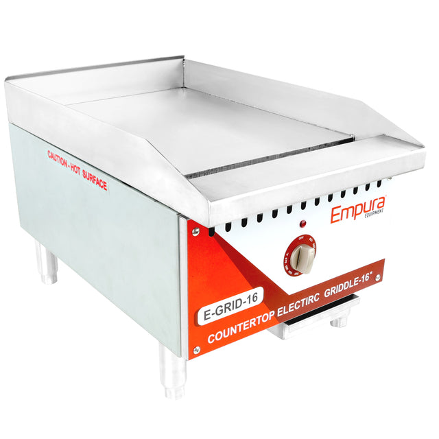 A stainless steel Empura electric countertop griddle with a smooth flat griddle surface, red and white control panel, single knob, four short legs, and a Caution: Hot Surface warning. The unit is labeled E-GRID-16.