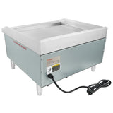 The Empura E-GRID-24 stainless steel griddle features raised edges, four sturdy legs, a power cord, and a caution label for hot surfaces. This electric countertop griddle is clean and displayed on a white background.