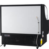 A large Empura refrigeration ice machine with a black frame and silver front panel stands on wheels. A hose is attached to the right side. Vents, a control panel, and warning labels are visible on the lower front section. Plain white background.