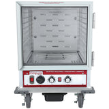 A stainless steel Empura heated holding cabinet with 12 pan capacity, glass door, control knobs, temperature display, and interior ventilation slots. The cabinet sits on four large caster wheels and features a warning label on top.