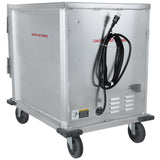 A large metal proofing cabinet with four gray wheels, a side door, and an electric cord coiled on the front. Warning labels and “CAUTION - HOT SURFACE” are printed in red text. This heated holding cabinet offers mobility and industrial durability.