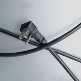 A black electrical plug with two metal prongs is attached to a cable that crosses another, forming an X shape on a smooth, light gray surface—like the minimalistic lines of an Empura refrigeration back bar cooler. The image is evenly lit.
