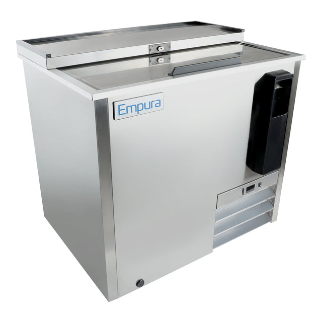 A stainless steel Empura refrigeration bottle cooler with a sliding top lid, horizontal handle, side bottle opener with cap catcher, vented panel, and blue and white Empura logo. The modern, boxy design makes it perfect for any commercial setting.