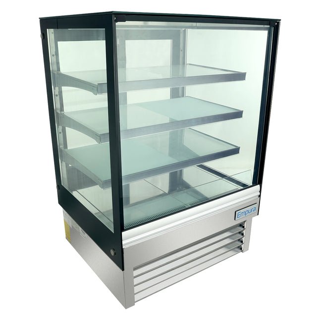 A commercial refrigerated display case with three clear shelves and a stainless steel base. Featuring LED lighting, a transparent front and sides, black frame, and “Empura” label, it’s perfect for showcasing food or products. Display is empty.