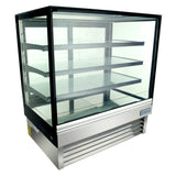 A refrigerated display case with a stainless steel base, three adjustable glass shelves, and LED lighting. Clear glass panels on all sides are framed in black, and the bottom features a vented grill for refrigeration. The interior is empty.