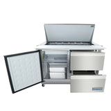 A stainless steel Empura refrigerated prep table features an open top lid with food pans, a sandwich salad mega top design, an open left door with shelves, and two open drawers on the right, all on caster wheels.