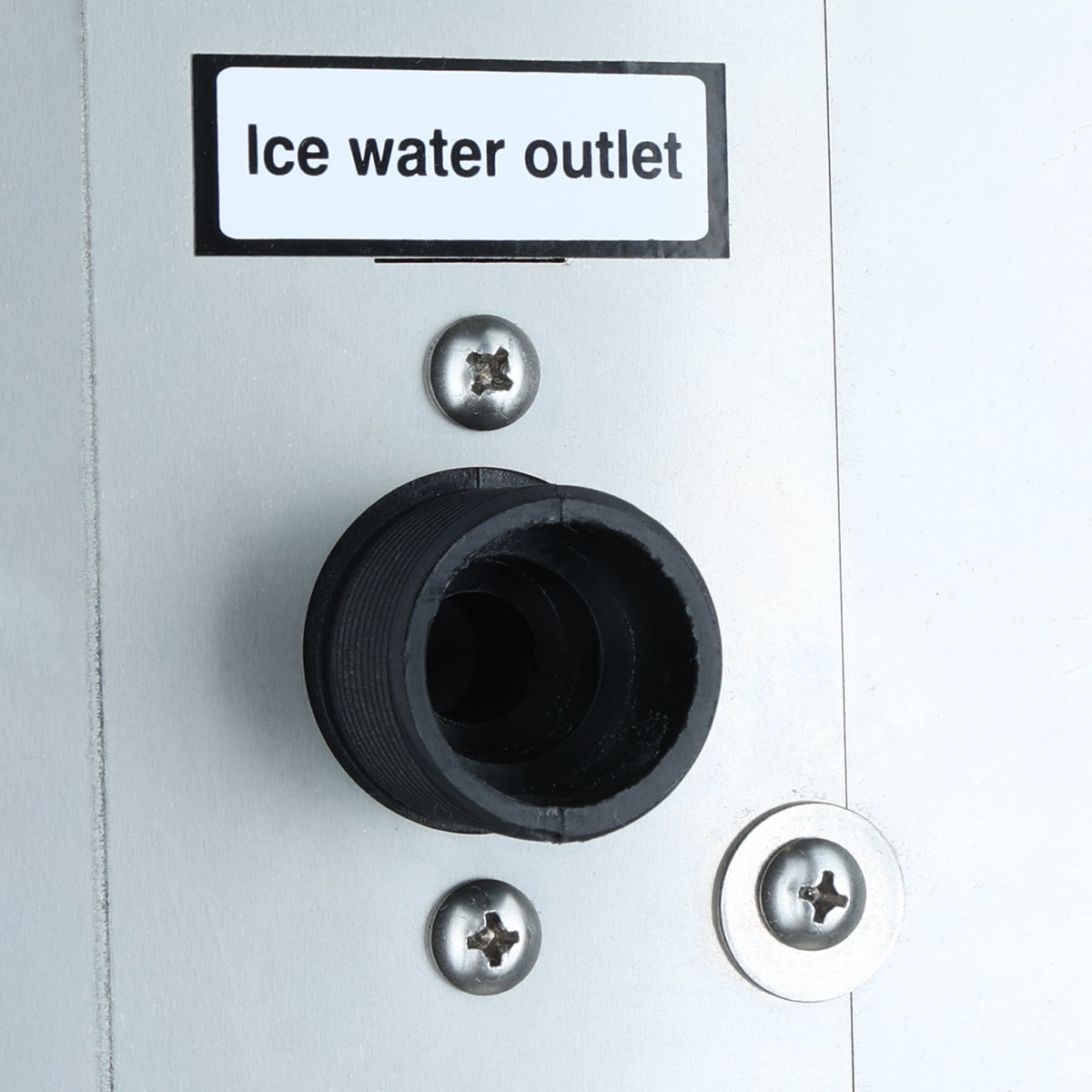 Close-up of a metal panel labeled Ice water outlet above a black circular fitting, secured by silver screws. The clean, industrial surface suggests it belongs to a commercial ice maker or cube-style ice machine.