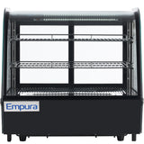 A black Empura refrigeration display case with a curved glass front, three wire shelves, interior LED lighting, and a branded logo panel at the bottom left. This countertop display refrigerator sits empty on short legs against a white background.