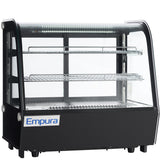 A black and glass Empura refrigeration countertop display refrigerator with two wire shelves and interior LED lighting. The curved glass front and blue and white Empura logo create a modern, sleek refrigerated display case for any setting.
