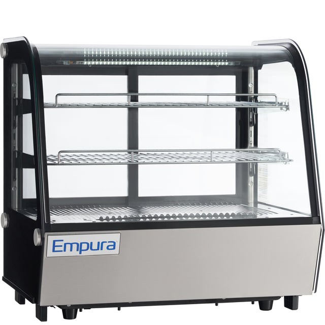 A commercial Empura refrigerated display case with glass sides and front, two wire shelves, and a metal lower panel. This illuminated countertop display refrigerator is designed to showcase food items professionally.
