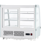 A white Empura refrigeration countertop display refrigerator with glass sides and sliding doors. This refrigerated display case features two wire shelves, a vented front panel, digital temperature readout at 3.6°C, black power switch, and an empty interior.