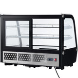 A black and silver Empura refrigerated display case with glass front and sides, two metal shelves inside, sliding doors at the back, a digital temperature display, ventilation grilles, and a power cord extending from the bottom right. The case is empty.