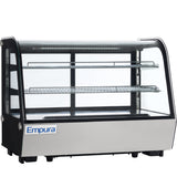 A commercial Empura refrigerated display case with a glass front and sides, two metal wire shelves, black frame, and stainless steel base. The well-lit countertop display case is empty, showcasing the Empura brand on the front.