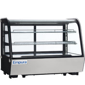 A commercial Empura refrigerated display case with a glass front and sides, two metal wire shelves, black frame, and stainless steel base. The well-lit countertop display case is empty, showcasing the Empura brand on the front.