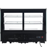 A black Empura refrigeration countertop display refrigerator with two clear sliding glass doors and three wire shelves inside. The base features ventilation grilles, a temperature display showing 57°F, a red power switch, and a power cord at the bottom right corner.