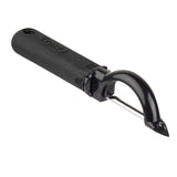 A black-handled vegetable peeler with a stainless steel, horizontal serrated edge and a pointed tip for removing blemishes. The ergonomic handle is thick and textured for grip, with “Prince” embossed on it. The peeler is positioned on a white background.