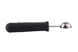 A melón baller with a black ergonomic handle and a small, round, stainless steel scooping end is shown lying horizontally on a white background, with the handle on the left and the metal scoop on the right.