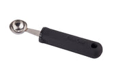 A stainless steel melón baller with a round scooping end and an ergonomic, black rubberized handle that reads FIRM GRIP. The handle features a hole at the end for hanging. The tool is isolated on a white background.