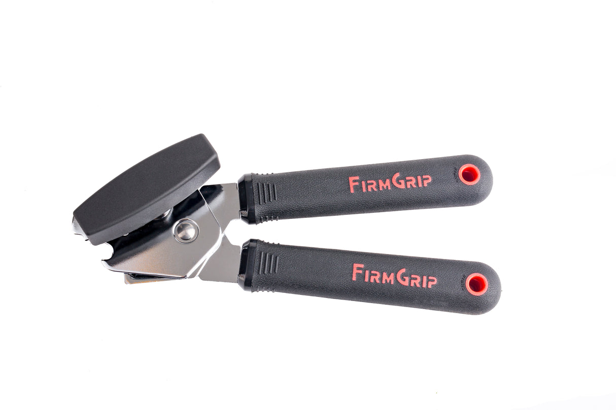 A black and silver FirmGrip Hand Can Opener with ergonomic black handles labeled “FIRM GRIP” in red text, isolated on a white background. This stainless steel can opener features a turning knob and visible cutting blade near the top.
